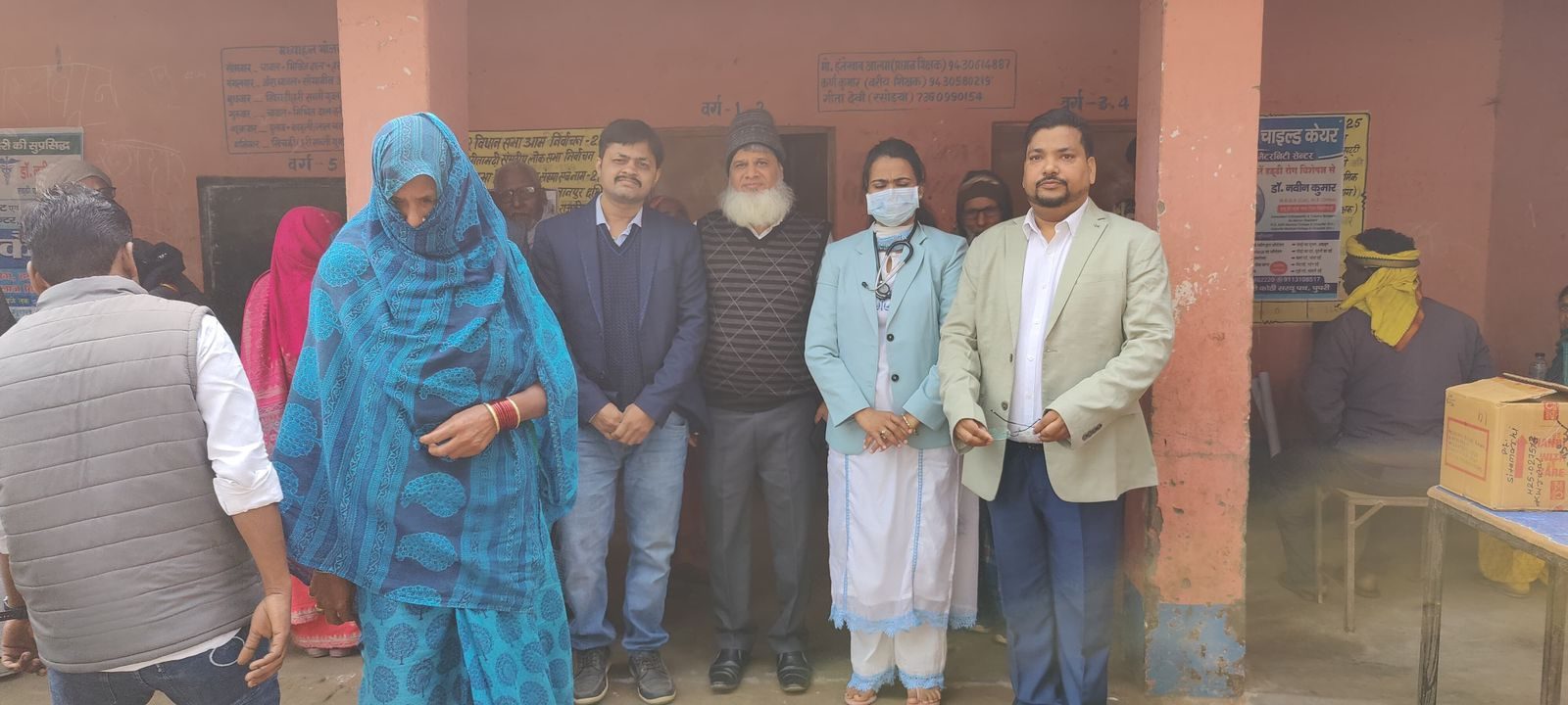 Doctors and team members with a patient at the free health camp